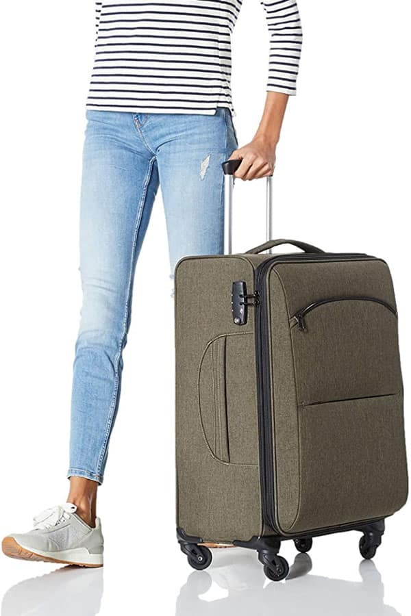 Woman rolling a budget-friendly hardside luggage bag