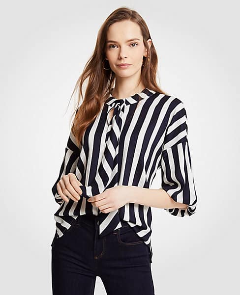 Black and white striped blouse with tie at the neck and puff sleeves