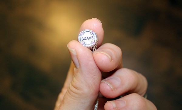 Close up of charm with Brave inscribed