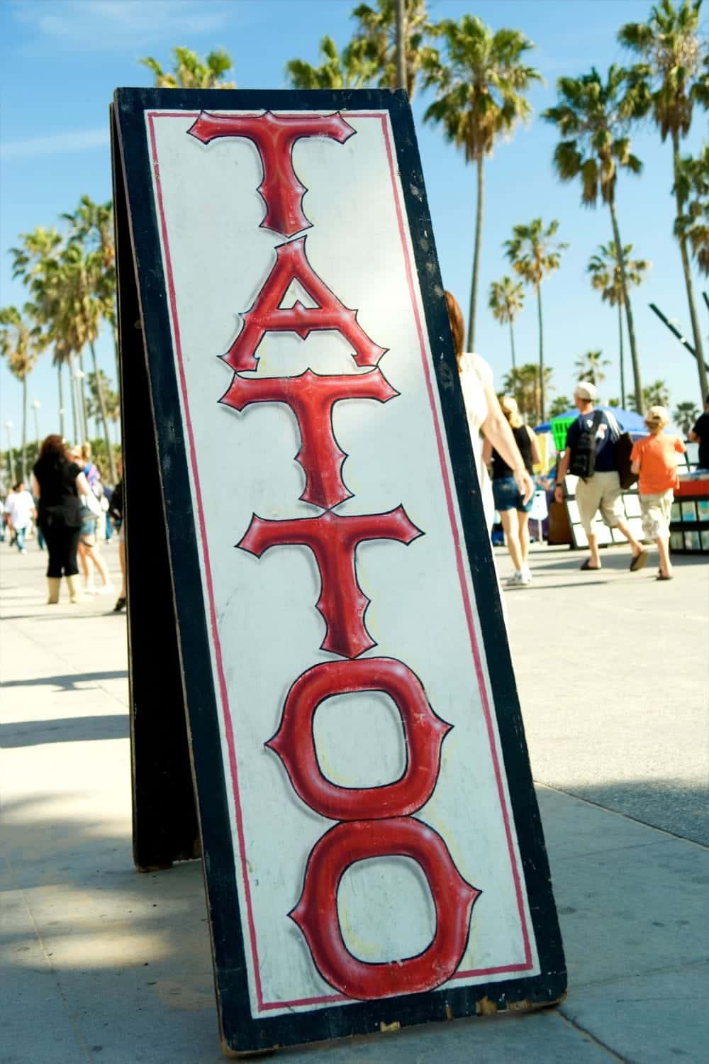 Sandwich board sign for a tattoo shop.