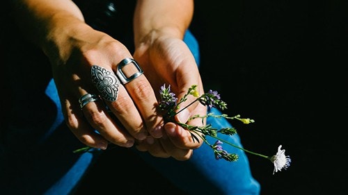 how to stack rings - close up of woman's hands with many rings