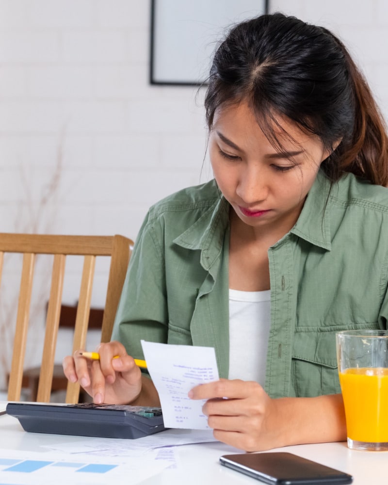 Woman works on household budget because of clothing inflation.