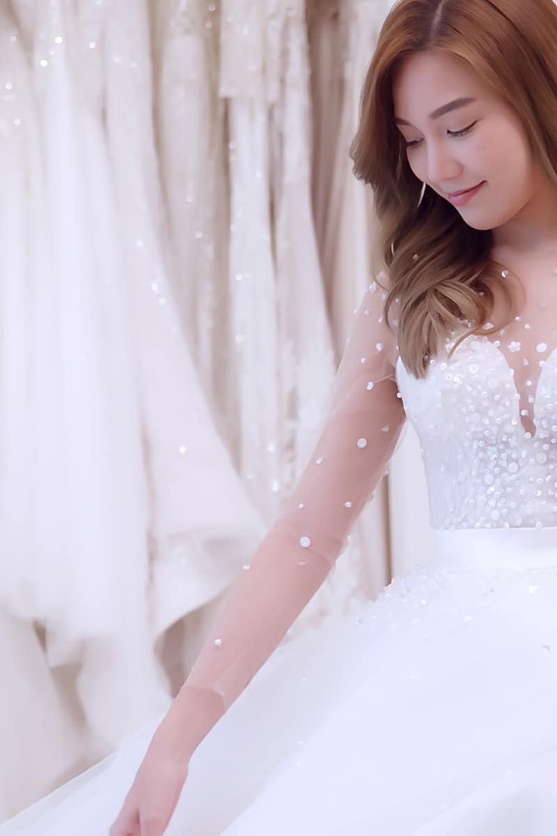 Woman tries on wedding gown chosen by David's Bridal wedding consultant.