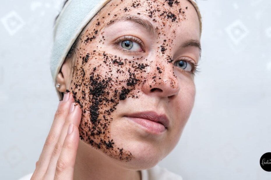 Woman applying scrub on her face