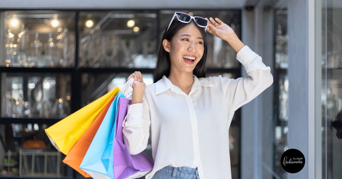 Happy woman holding colorful shopping bags.