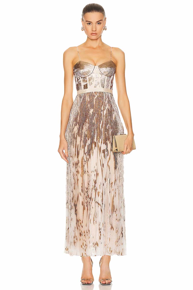 Model wears strapless, metallic gown against white background. 