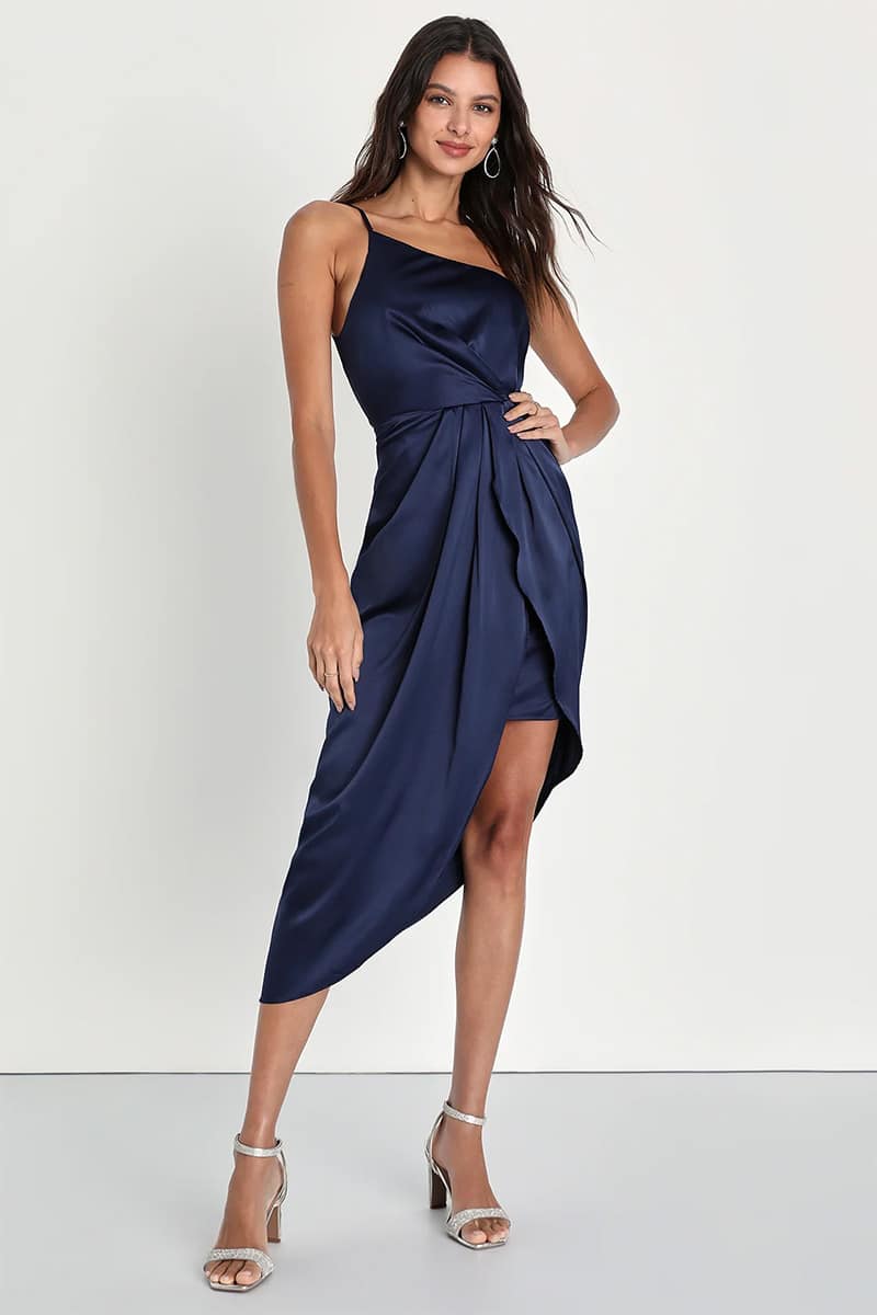 Model wears navy, high-low dress.