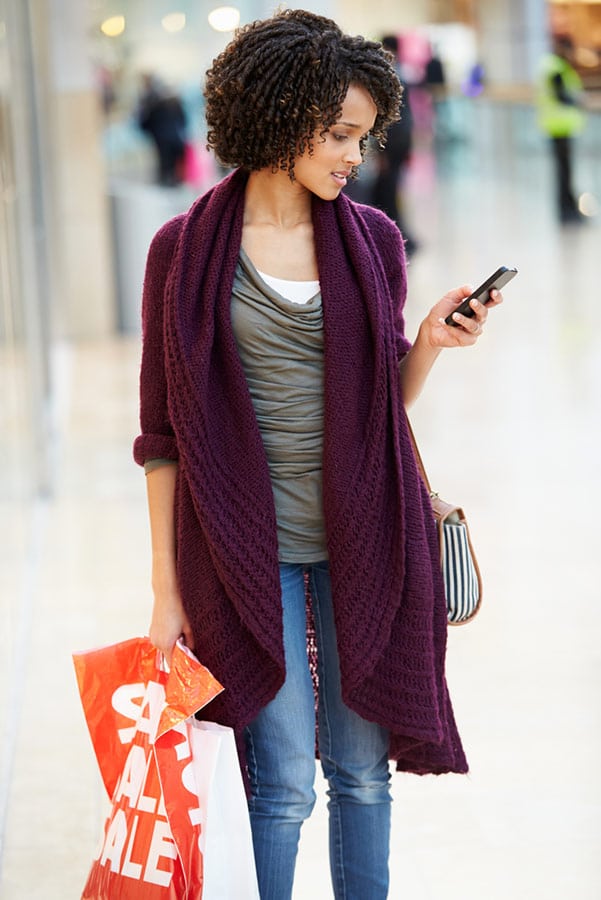 Woman price shopping on her phone