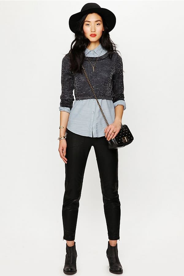 Woman wearing cropped sweater with longer shirt beneath