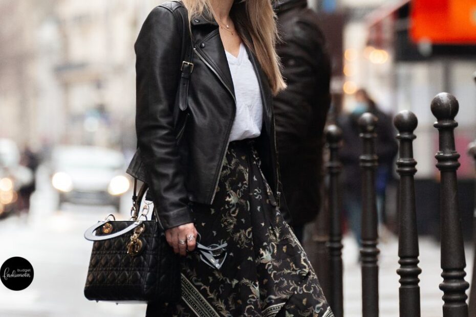 Black leather jacket, white shirt, patterned skirt