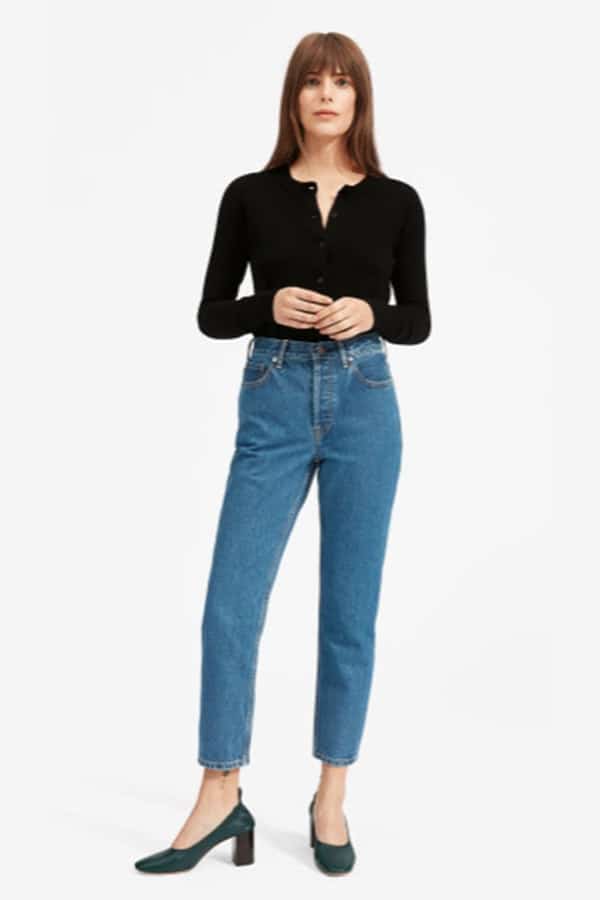 Woman wearing sleek top and mom jeans