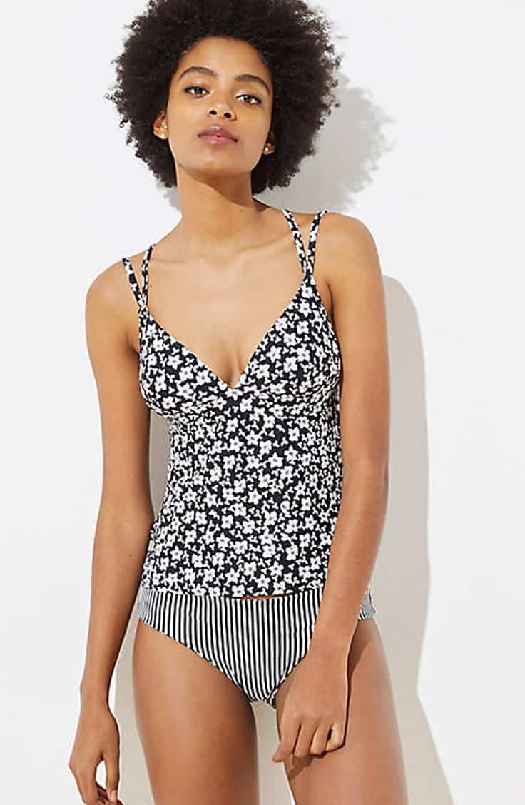 Tall woman wearing floral tankini top and striped bottoms