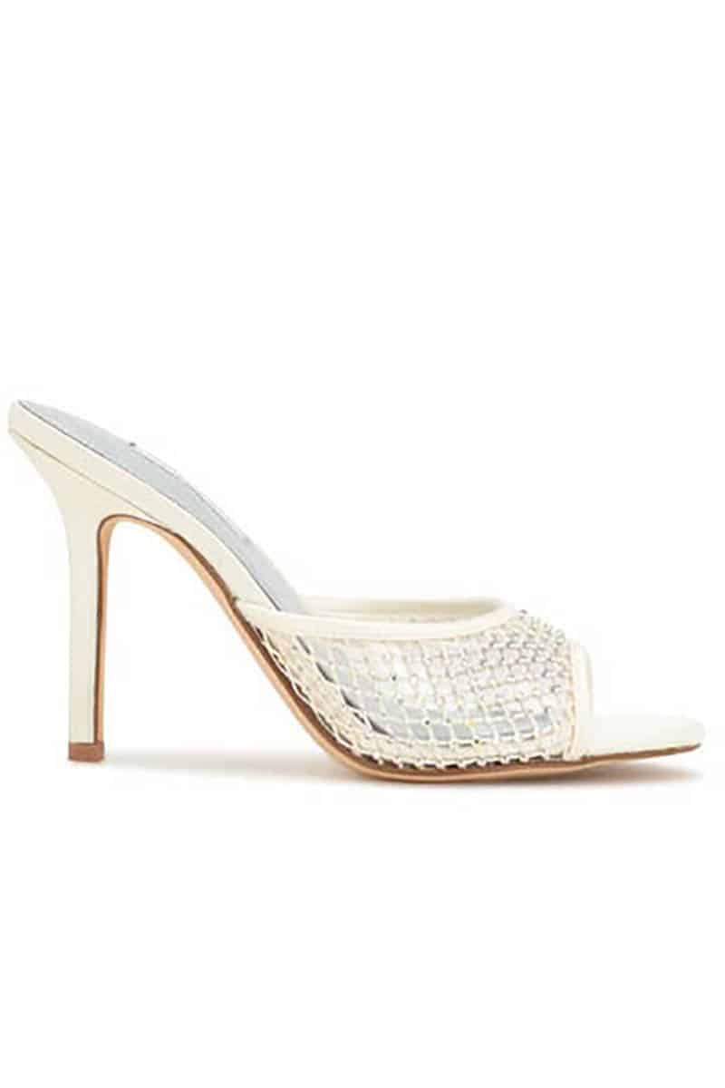 Ivory slide sandal with mesh panel.
