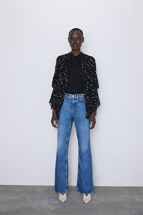 Woman wearing black polka dot flowing jacket