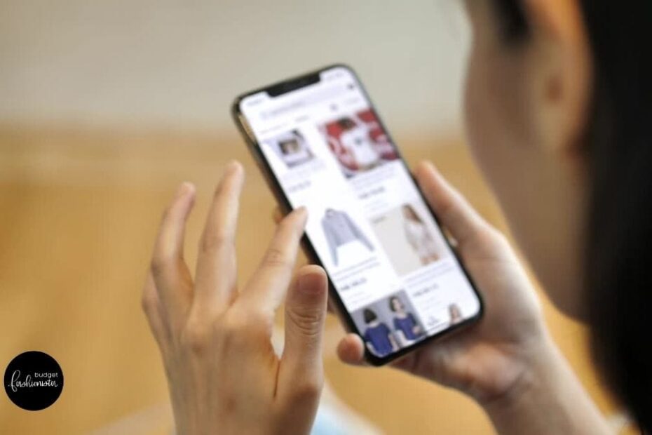 Close up of woman shopping popular clothing brands on smartphone