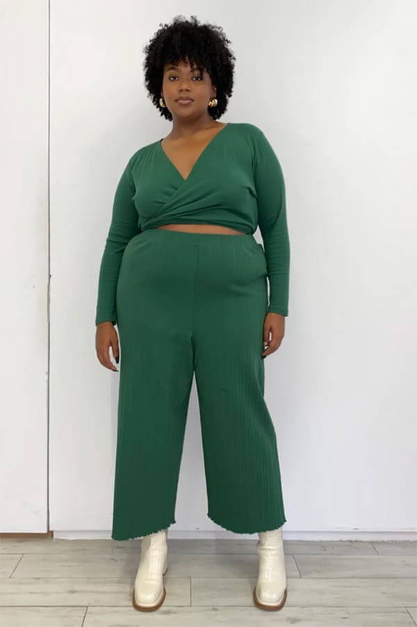 Model wears knit pants in plus-size.