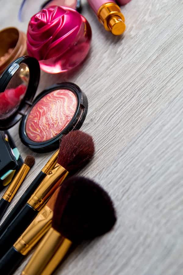 Collage of makeup and makeup brushes to represent makeup expiration dates.