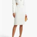 Model wears white dress with sheer panels.