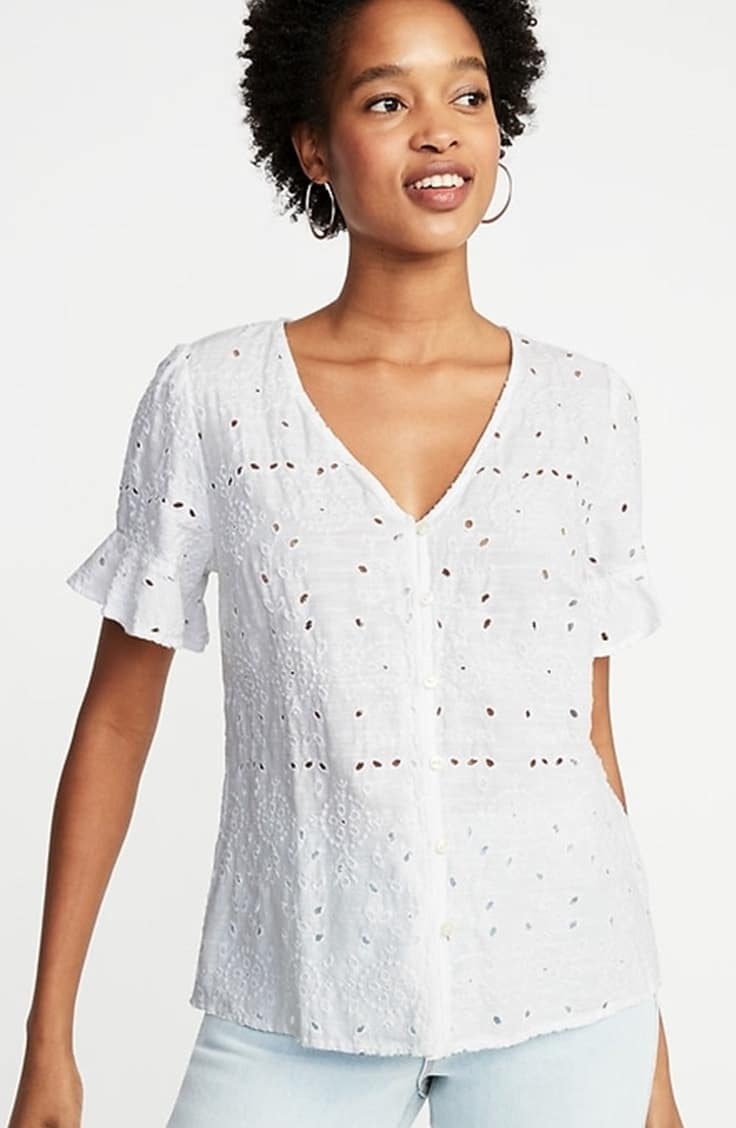 Woman wearing white open work shirt with jeans