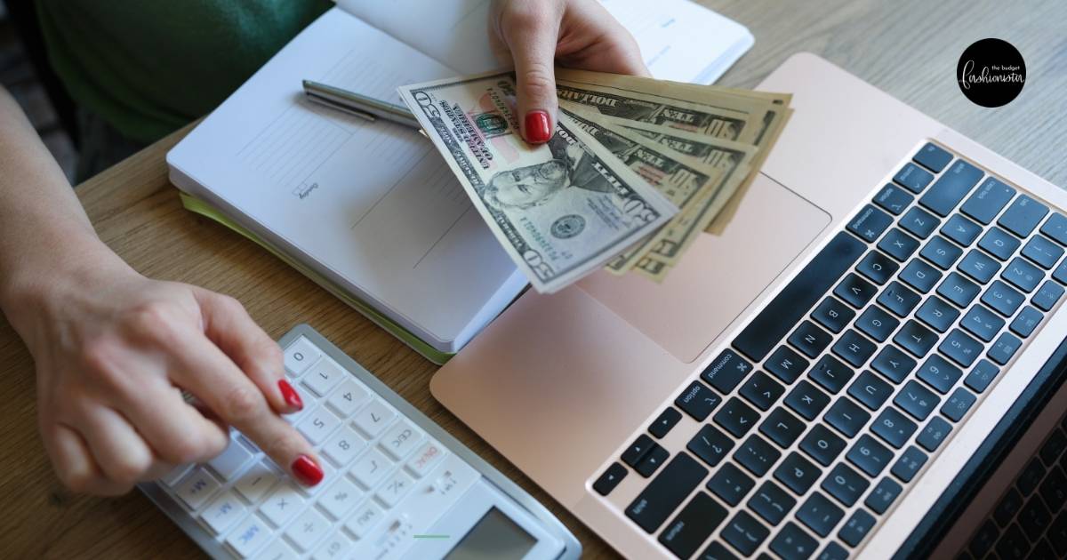 Hand holding cash over laptop to represent stagflation and inflation