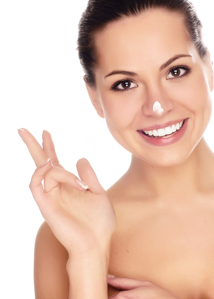 Woman applying facial cream 