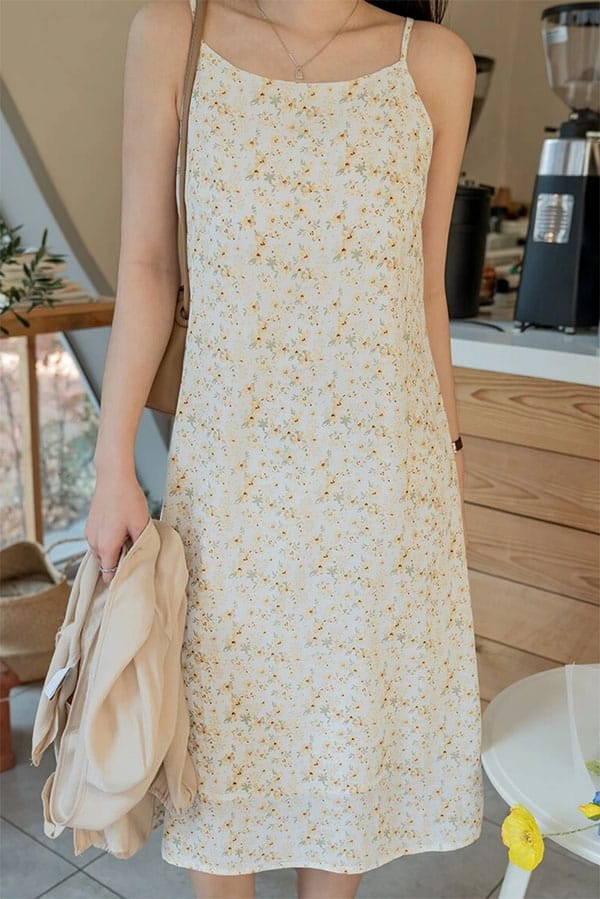 Close up of model wearing floral slip dress.