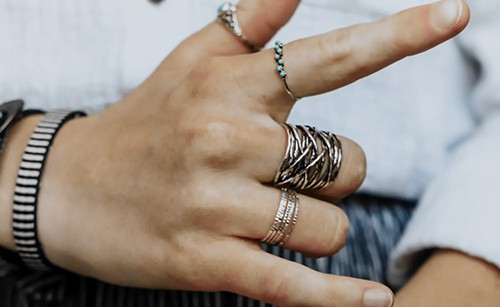 Close-up of woman's hand with stacked rings