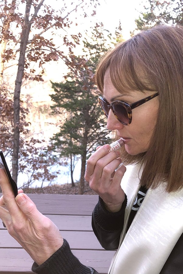 Catherine Brock applying tinted lip balms by Waxing Kara