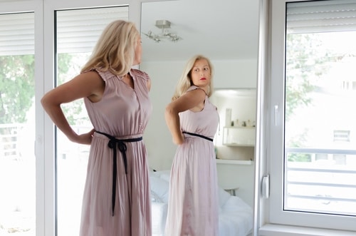 Woman trying on pink dress