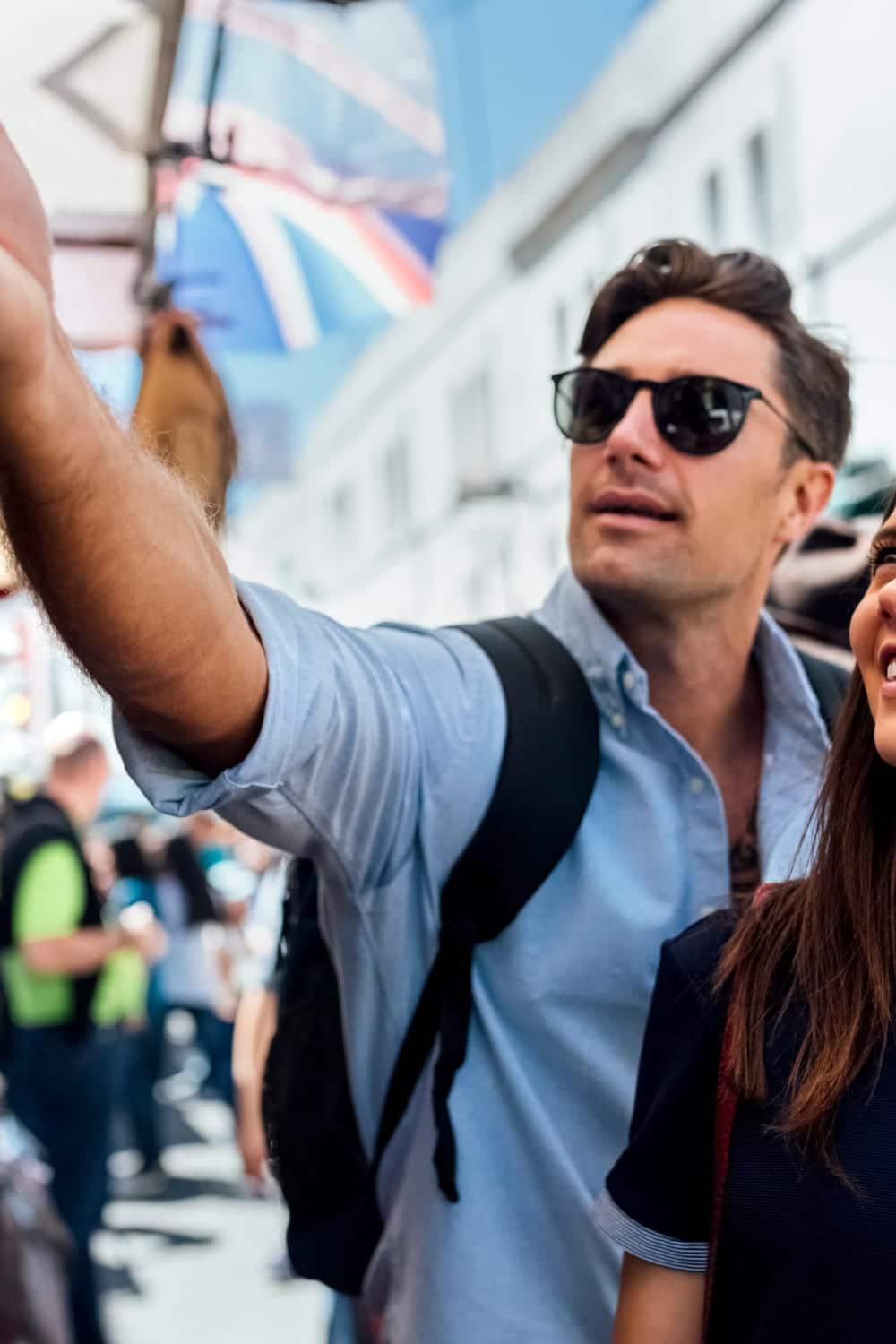 Couple enjoying cheap shopping in London at Portobello Road Market.