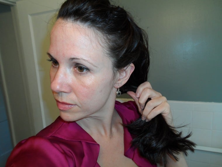 Step 5 of updo tutorial: pull hair to the side.