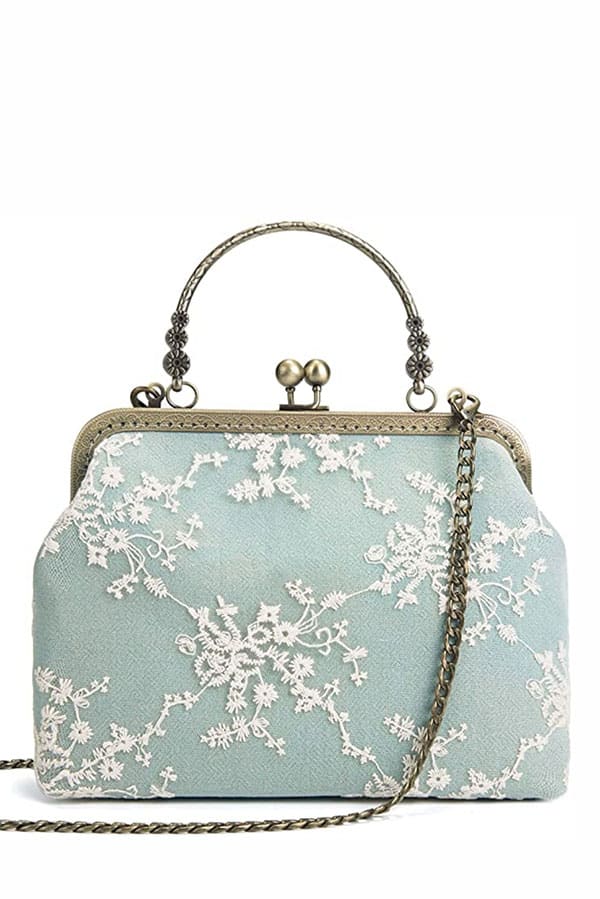Product shot of mint green vintage handbag.
