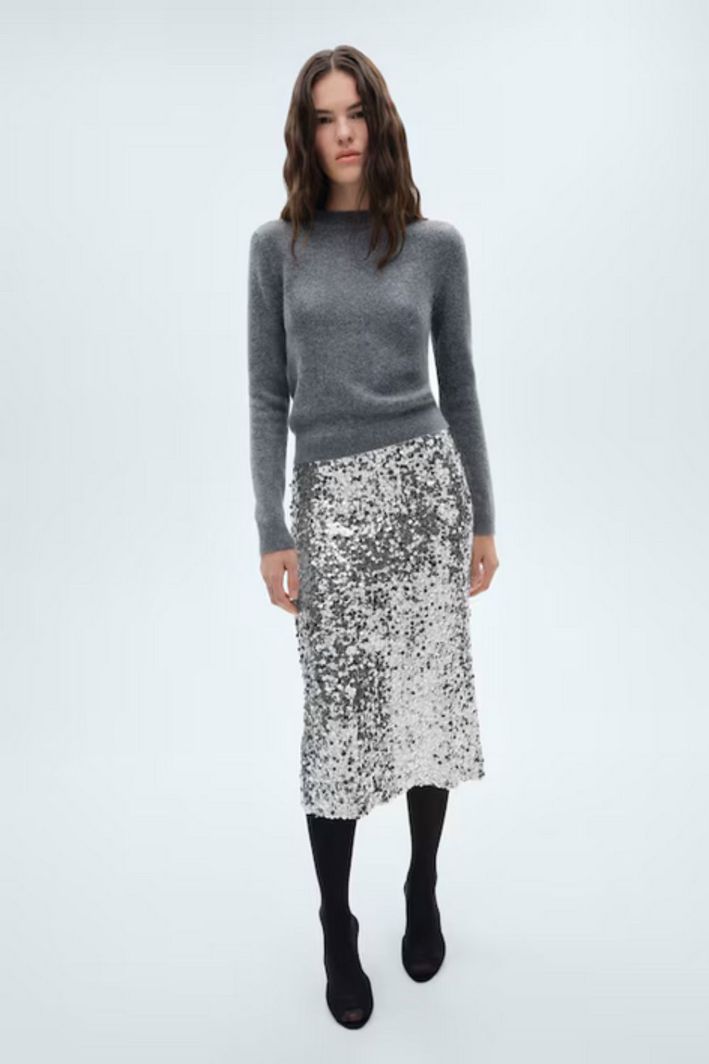Model wearing sequin skirt from Mango with knit top