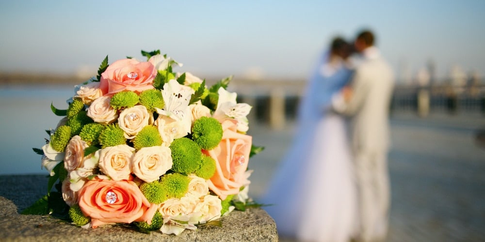 Wedding bouquet with bride in the background