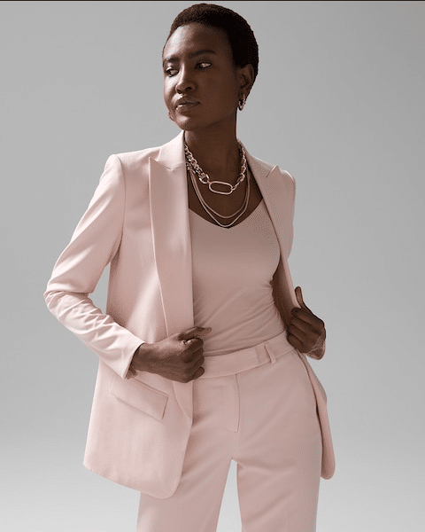 Model wears women's work suit in pink.