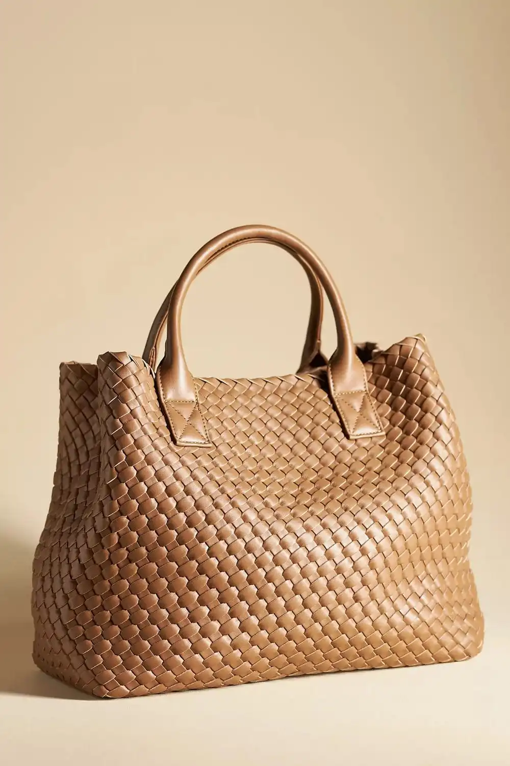 Brown tote bag on brown background.