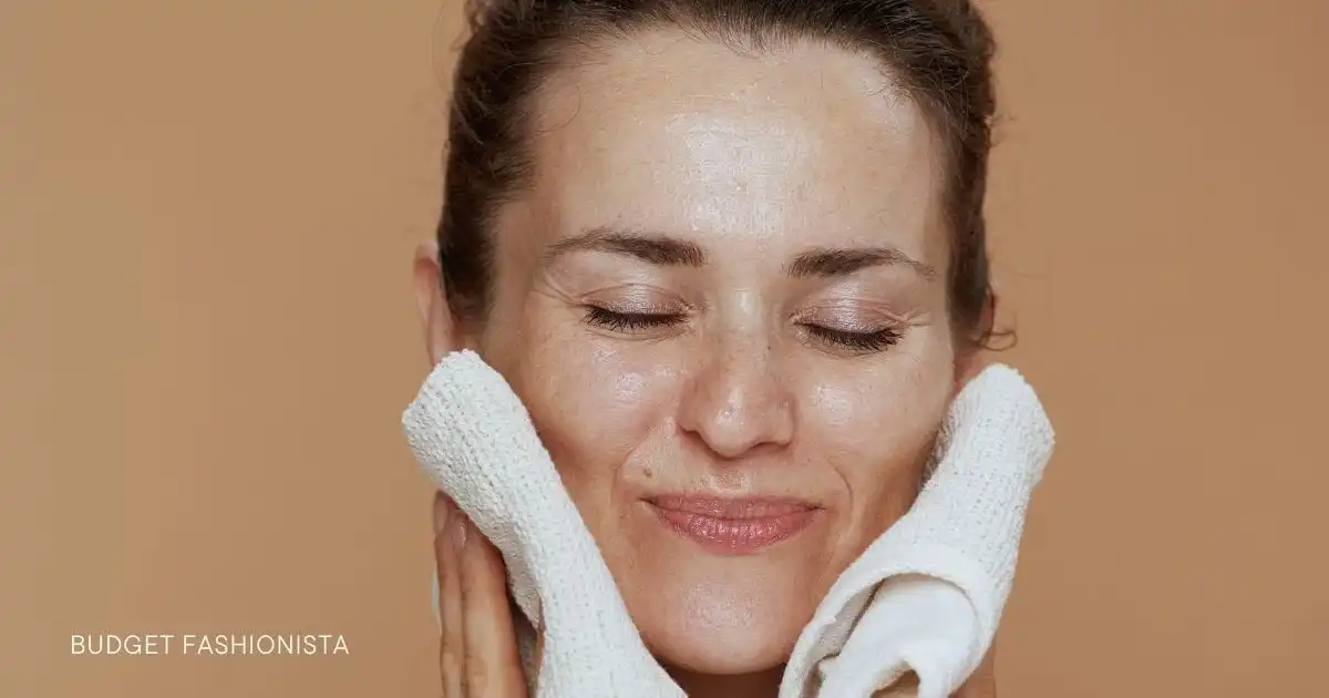 Woman holding washcloths against her face.